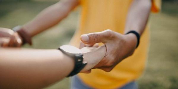 Two people holding hands