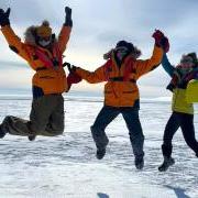 Cassandra Brooks, Ulyana Horodyskyj Peña and Zephyr Sylvester jumping in Antarctica