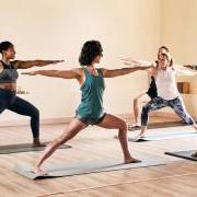 Women and men doing yoga in a studio