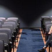 Two people sitting in an auditorium