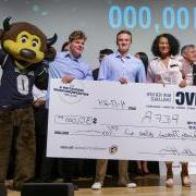 The Refr team poses with Chip, the Buffaloes mascot, and an oversize winning check on a stage.