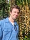 Ryan St Laurent standing next to flowering plants