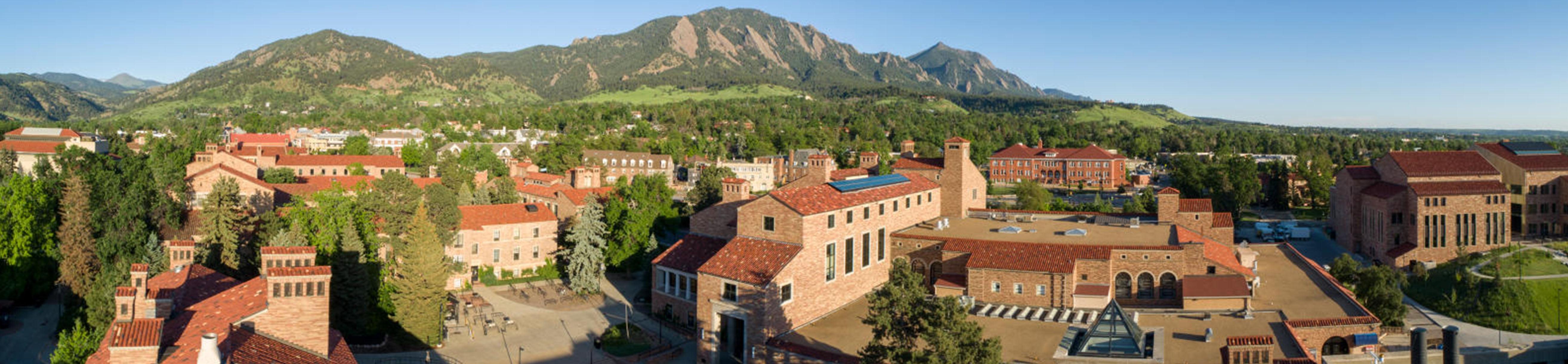 aerial view of campus with flatirons and mountains in the background