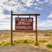 Photo of the "Welcome to Colorful Colorado" sign on a sunny bright day.