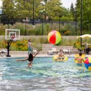 Photo of students hitting a large beach ball around the buff pool.