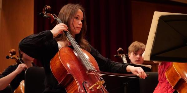 Student cellist on stage