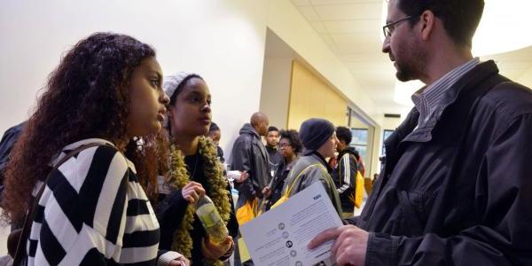 Staff talking to students