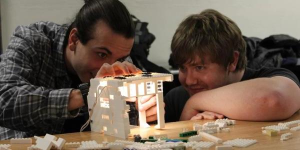 Two students work on a Lego lighting project during their architectural lighting design class