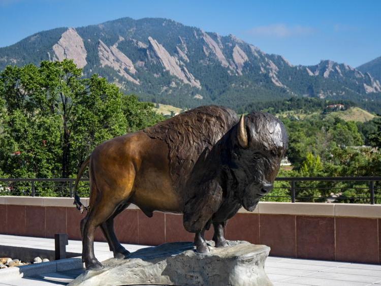 Ralphie sculpture with Flatirons in background