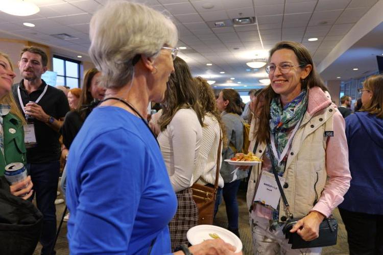 Conference attendees catch up with each other