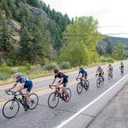 Cyclists riding on a road in the mountains