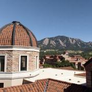 Tops of campus buildings with Flatirons in the background