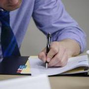 Employee writing in notebook during a workshop