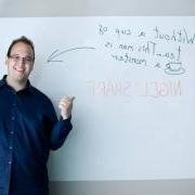 Nigel Sharp next to a whiteboard that reads "Without a cup of tea... This man is a monster"