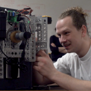 Senior Kenzy O'Neill makes an adjustment to his team's safecracking robot.