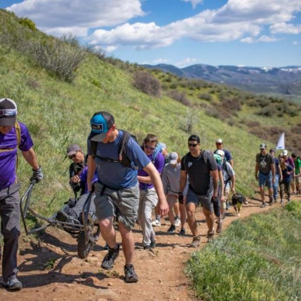 hikers helping a hiker with adaptive hiking 